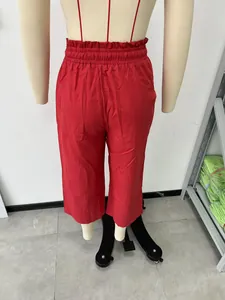 Detailed back view of red high-waisted linen wide-leg pants shown on a mannequin