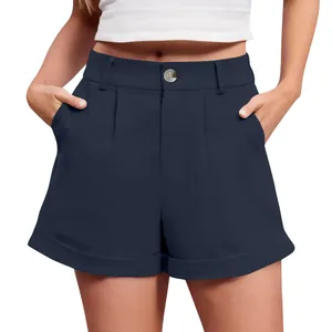 Detailed view of navy blue high-waisted cotton linen shorts with pleats and cuffs.