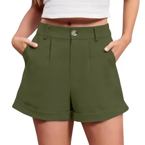 Detail of high-waisted olive green linen shorts with button and pleated front