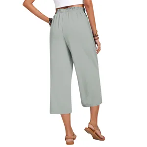 Back view of women's high-waisted linen wide-leg cropped pants in light sage green