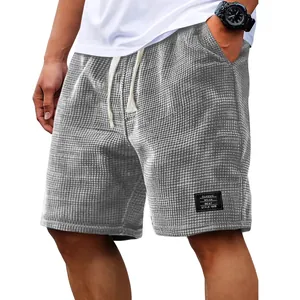 Men's grey waffle knit casual shorts with drawstring waist and classic patch detail