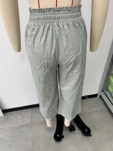 Detail view of women's sage green linen wide-leg pants with elastic high waist.