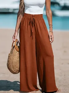Close-up detail of women's brown linen wide-leg pants featuring a drawstring waist