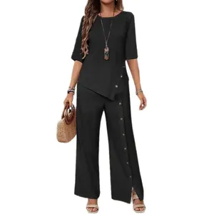 Full view of elegant black two-piece set featuring irregular hem and button details.