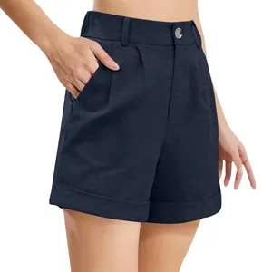 Close-up detail of navy blue high-waisted cotton linen shorts with button and pockets