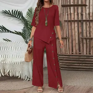 Elegant red two-piece set featuring asymmetrical top and wide-leg trousers for women.