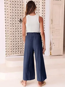 Rear view of blue high-waisted wide-leg trousers with elastic waistband for casual wear