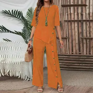 Women's irregular hem orange two-piece set with button details and wide-leg trousers