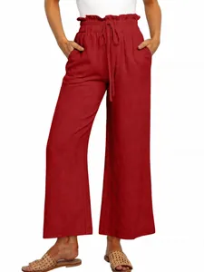 Detail view of red wide-leg trousers featuring an elastic drawstring waist and loose fit