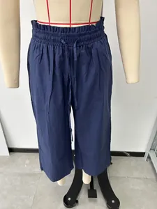 Detailed front view of navy blue high-waisted linen wide-leg trousers on a mannequin