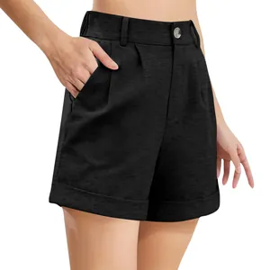 Detail of black high-waisted cotton-linen shorts showing pockets and button closure