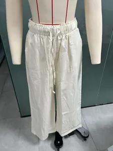 Detail view of off-white cotton linen wide leg drawstring casual pants on mannequin