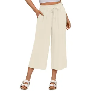 Detail of women's linen wide-leg pants with elastic drawstring waist and side pockets