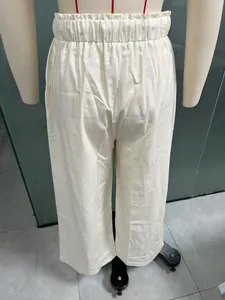 Detailed back view showing the texture and elastic waistband of white linen trousers.