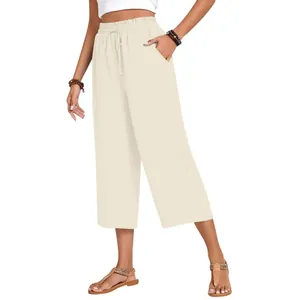 Woman wearing cream high-waisted linen wide-leg pants with elastic drawstring waist