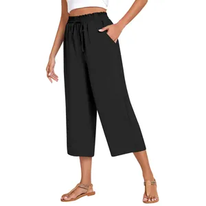 Detail view of women's black high-waist linen pants with drawstring and pockets.