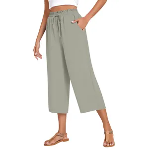 Macro view of high-waisted linen casual pants featuring elastic drawstring and side pockets