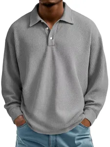 Detailed shot of grey waffle knit polo shirt showing textured fabric and collar