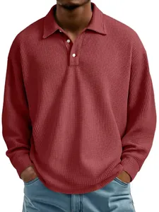 Detailed view of the texture on a men's red waffle knit long-sleeved polo shirt