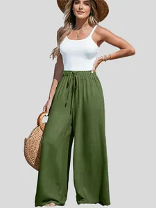 Woman wearing olive green high-waisted wide leg cotton linen trousers with drawstring