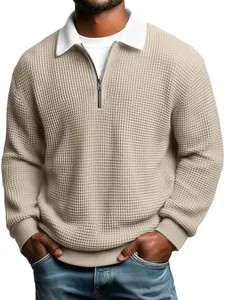 Detail of beige waffle knit quarter-zip polo shirt with white contrast collar.