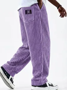 Macro view showing the thick corduroy texture and retro patch of men's purple pants
