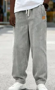 Macro view of grey corduroy casual trousers showing fine texture and drawstring waist detail