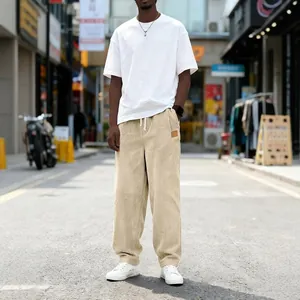 Full-length view of men's beige corduroy straight-leg pants with white drawstring