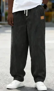 Close-up view of men's dark gray corduroy drawstring loose fit casual trousers for autumn wear