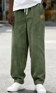 Detailed texture of men's green corduroy drawstring casual trousers in loose fit style.