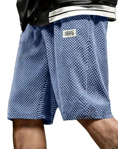 Detailed macro view of blue jacquard textured fabric on men's summer sports shorts