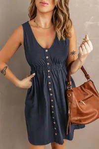 Detail shot of a navy blue sleeveless dress with button-front and elastic waist