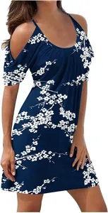 Detail view of a navy blue cold-shoulder summer beach dress with white floral pattern