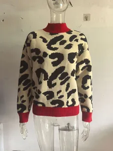 Detailed view of women's leopard print knit sweater featuring a red ribbed turtleneck and cuffs