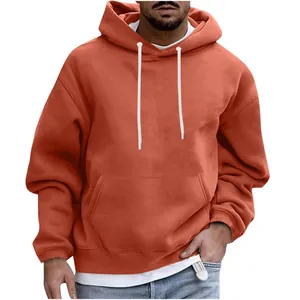 Detail of a men's orange oversized hoodie with drawstring and kangaroo pocket.