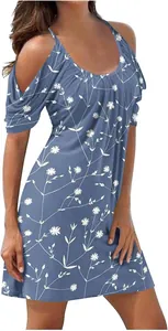 Detail view of a blue cold-shoulder summer dress with a white floral beach print
