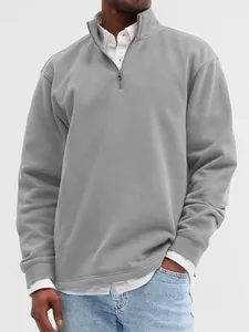 Detailed view of grey quarter-zip stand collar sweatshirt for men in a layered look.