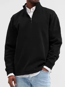 Close-up detail of black men's quarter-zip sweatshirt with stand collar and metal zipper