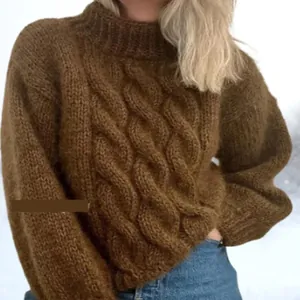 Close-up detail of brown chunky cable knit turtleneck sweater showing texture