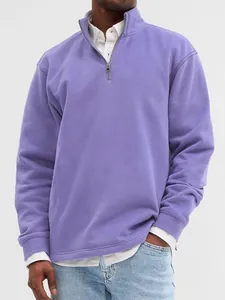 Detail view of a men's purple half-zip pullover sweatshirt featuring a stand collar design