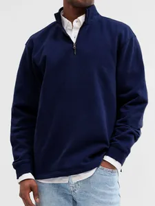 Detail view of a navy blue men's quarter-zip sweatshirt with stand collar styling