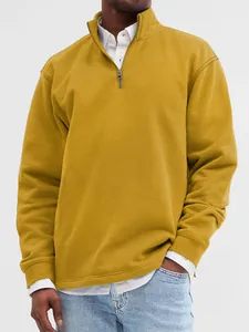 Detailed view of a mustard yellow men's half-zip stand collar sweatshirt on model