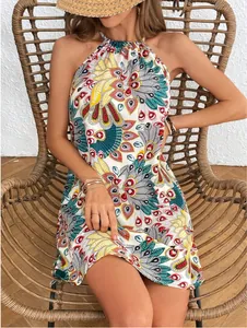 Detailed view of a vibrant peacock print halter neck mini dress for summer.