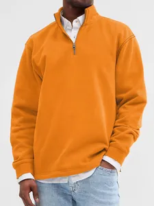 Close-up showing the texture and zipper detail of an orange stand-up collar sweatshirt