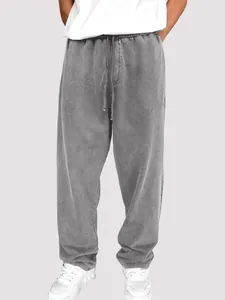 Vue complète du pantalon de jogging gris délavé pour hommes avec cordon de serrage.