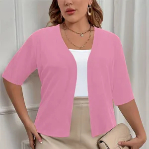 Macro view of elegant plus size pink short sleeve open front knit cardigan on model