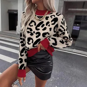 Detail view of leopard print turtleneck sweater with red ribbed trim and cuffs