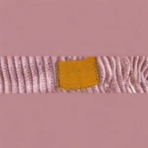 Detailed view of pink corduroy shorts with a minimalist rectangular leather patch