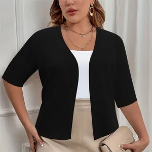 Detailed view of women's elegant black plus size short sleeve open front cardigan shrug.
