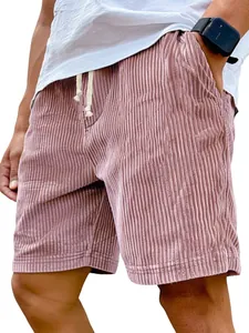 Close-up detail of men's pink corduroy shorts with white drawstring and loose fit.